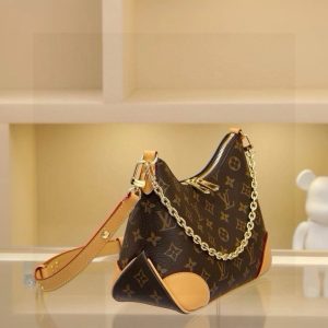 Alternative view of Odeon Small Handbag, featuring Monogram canvas and reinforced leather corners for a vintage feel. The adjustable shoulder strap allows for comfortable shoulder or crossbody wear, while the easy-access zipper provides convenient access to essentials. Dimensions: 27.0 x 16.0 x 10.0 cm